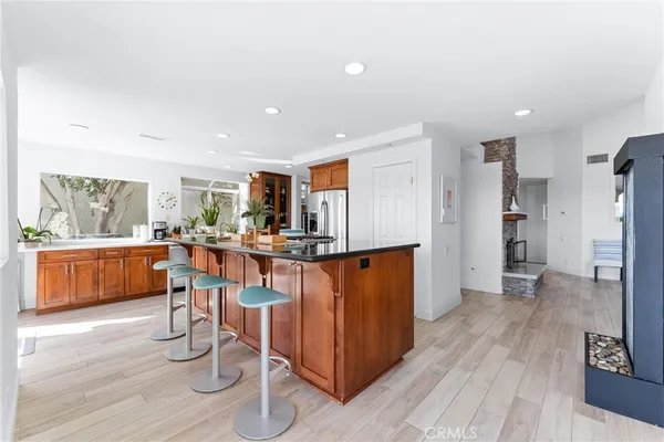 a view of kitchen with stainless steel appliances refrigerator dining table and chairs