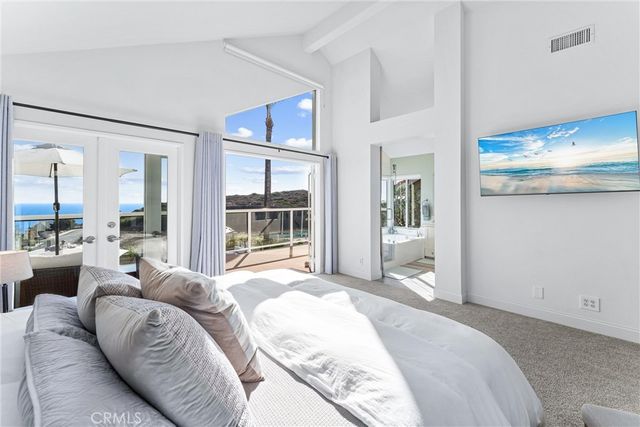 a spacious bedroom with a large bed and a large window