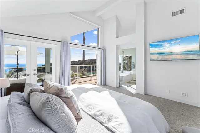 a spacious bedroom with a large bed and a large window