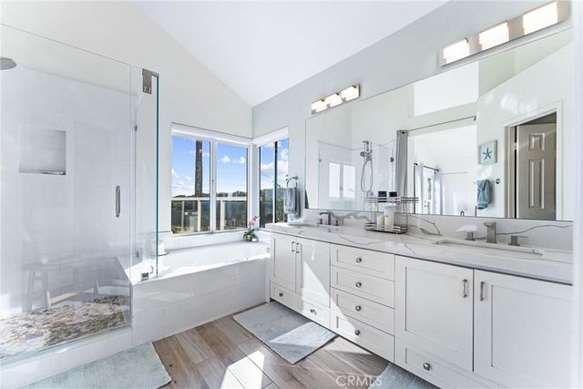 a bathroom with a granite countertop sink mirror and a bathtub