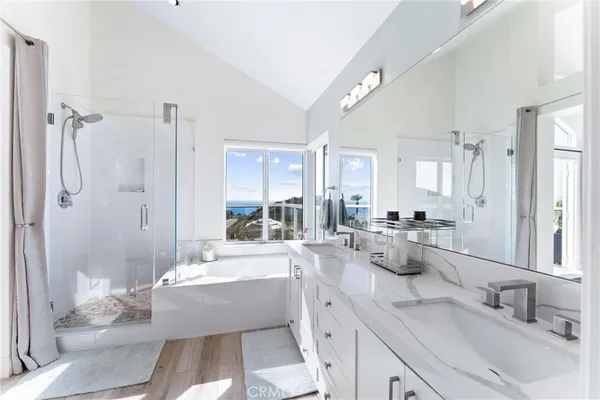 a large bathroom with a tub sink shower and mirror