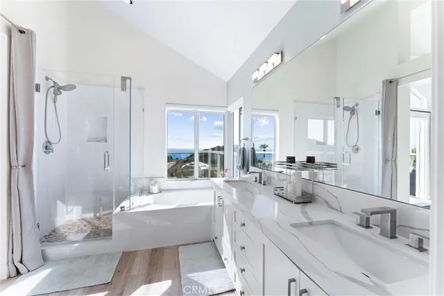 a large bathroom with a tub sink shower and mirror