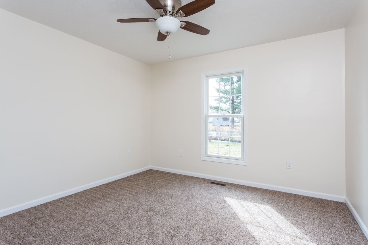 227 Harriston Road Grottoes, VA 24441 - Photo 14 of 25 an empty room with a window and a fan