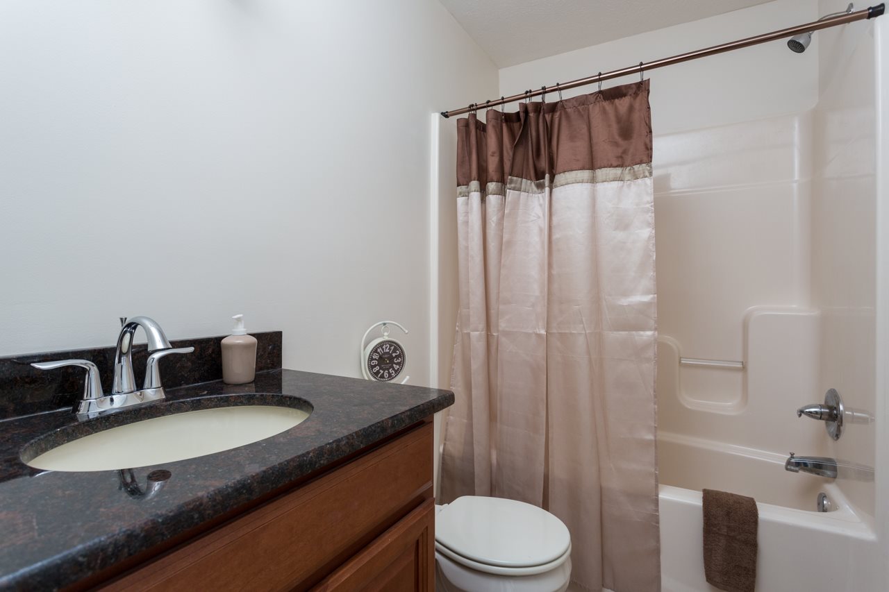 227 Harriston Road Grottoes, VA 24441 - Photo 15 of 25 a bathroom with a granite countertop sink toilet and shower
