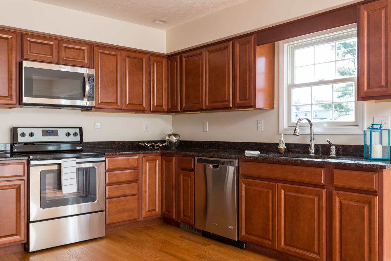 227 Harriston Road Grottoes, VA 24441 - Photo 6 of 25 a kitchen with granite countertop wooden cabinets stainless steel appliances and a window