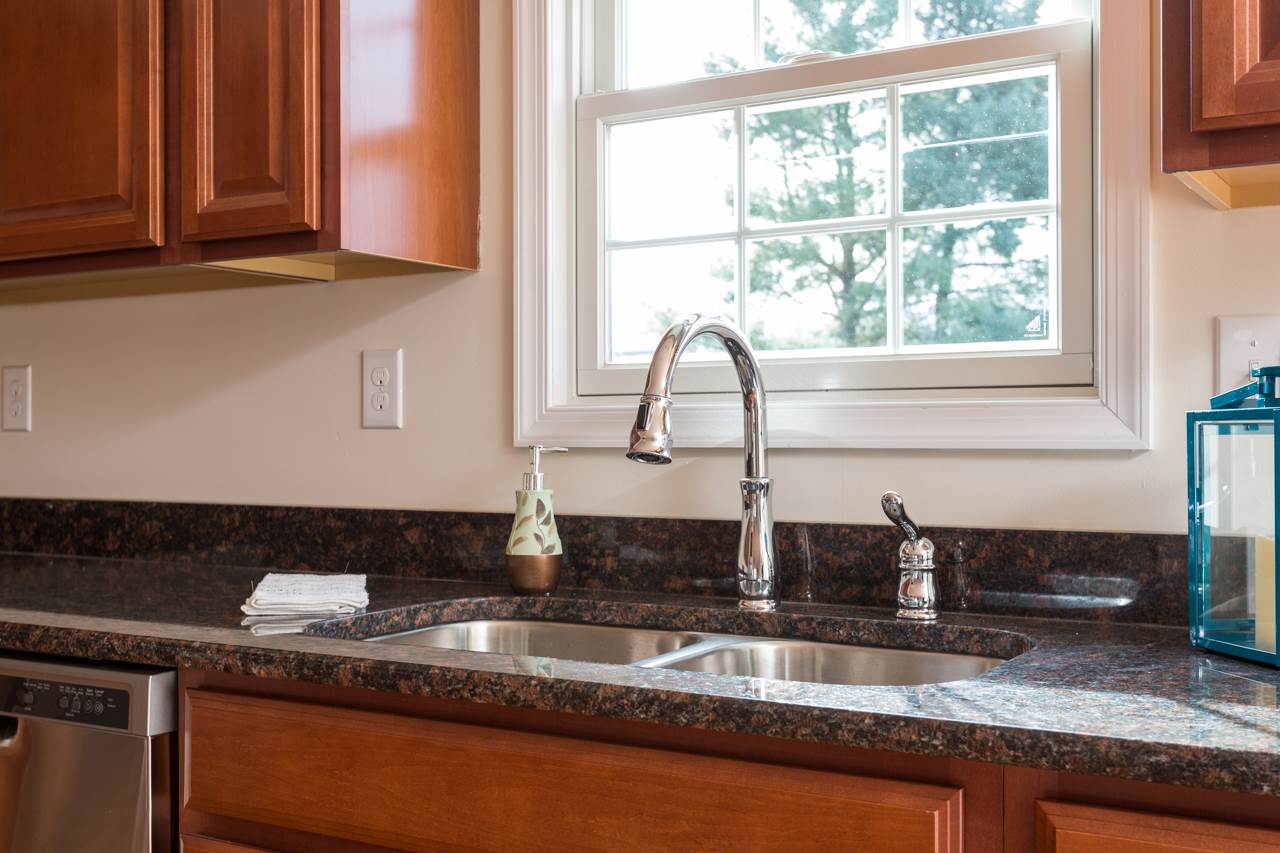 227 Harriston Road Grottoes, VA 24441 - Photo 7 of 25 a kitchen with granite countertop a sink and a window