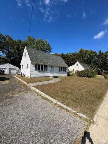 a view of white house with a yard