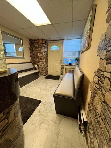 a living room with lots of furniture and a painting on the wall