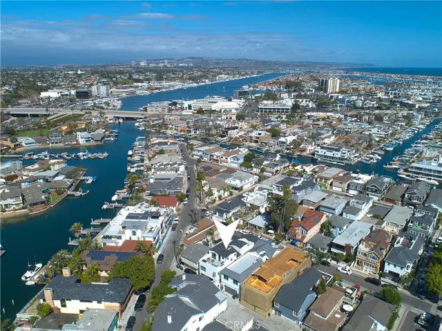 an aerial view of a city with ocean view in back