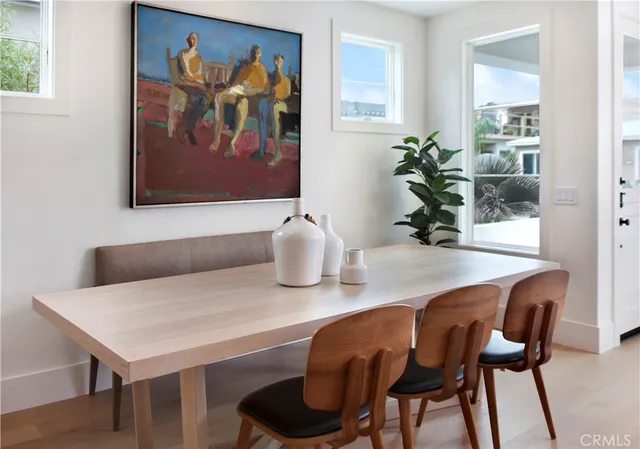 a dining room with furniture and wooden floor