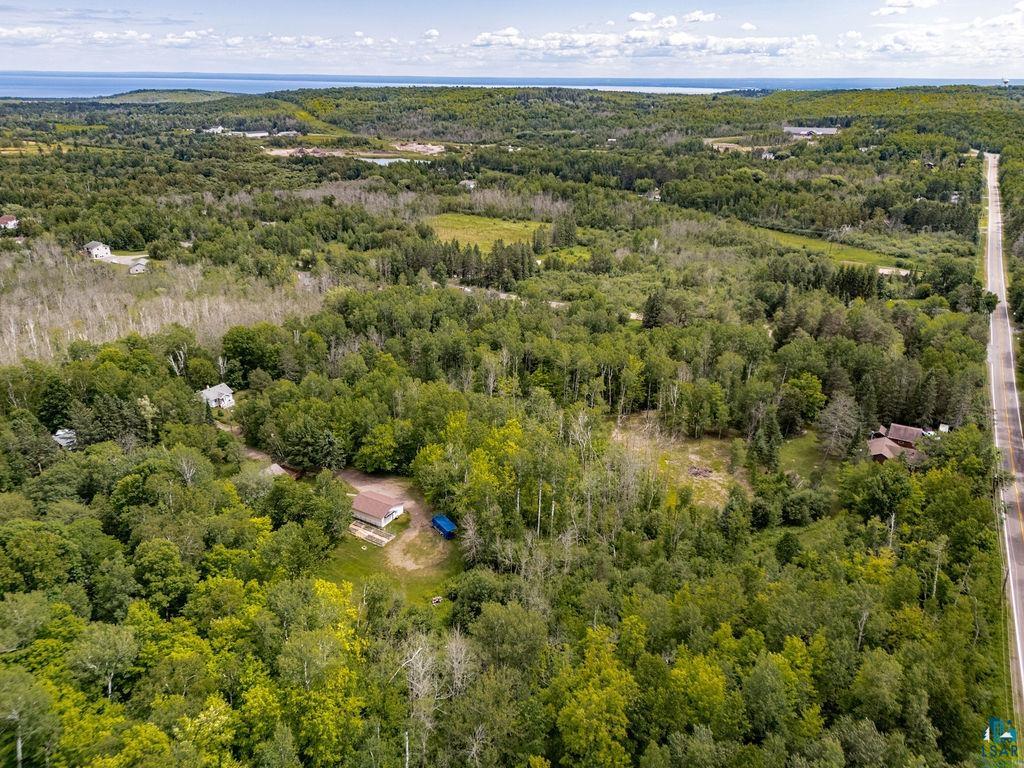 5025 Reid Road Duluth, MN 55803 - Photo 43 of 51 Expansive forested parcel with a visible body of water in the distance