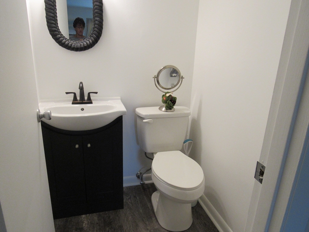 2 Shadowbrook Lane, Unit 50 Milford, MA 01757 - Photo 17 of 26 a bathroom with a toilet a sink and a mirror