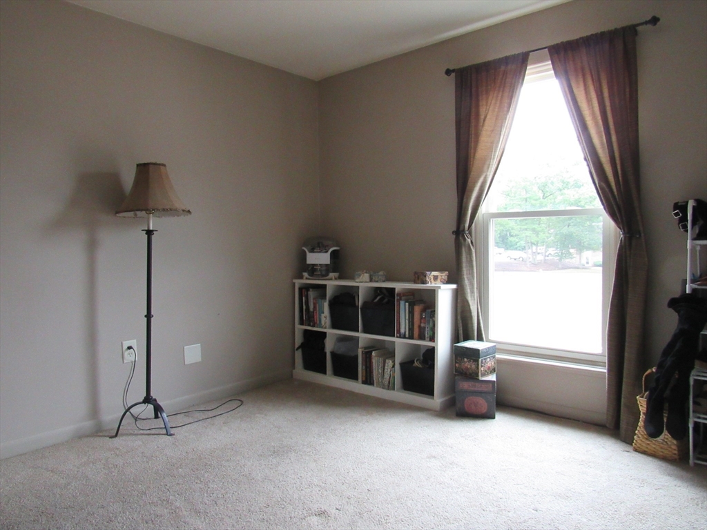 2 Shadowbrook Lane, Unit 50 Milford, MA 01757 - Photo 21 of 26 a view of an empty room with a window and kitchen view