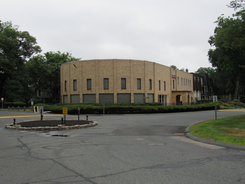 2 Shadowbrook Lane, Unit 50 Milford, MA 01757 - Photo 22 of 26 a city view with tall buildings and a cars park side of street