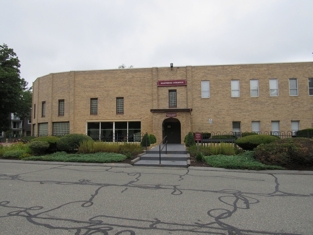 2 Shadowbrook Lane, Unit 50 Milford, MA 01757 - Photo 23 of 26 a front view of a house with a garden