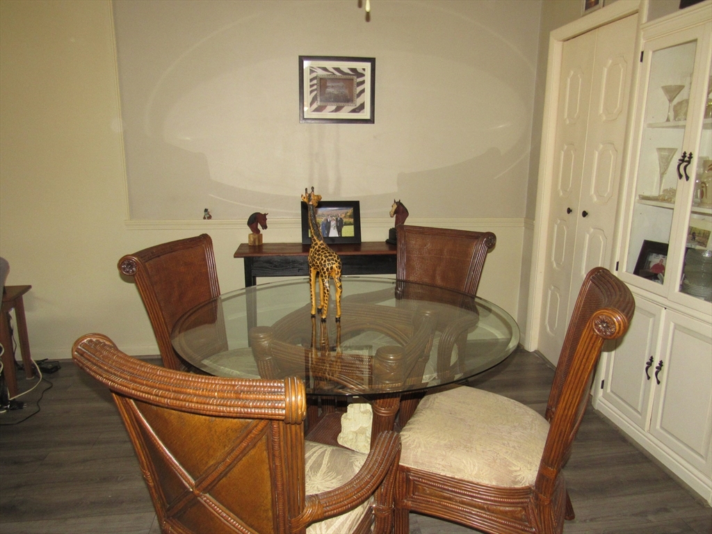 2 Shadowbrook Lane, Unit 50 Milford, MA 01757 - Photo 7 of 26 a view of a dining room with furniture and wooden floor