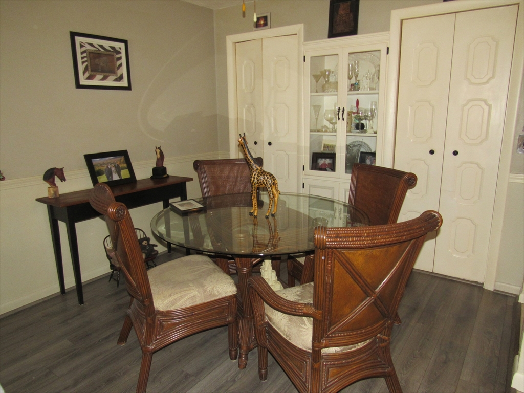 2 Shadowbrook Lane, Unit 50 Milford, MA 01757 - Photo 8 of 26 a dining room with furniture and wooden floor