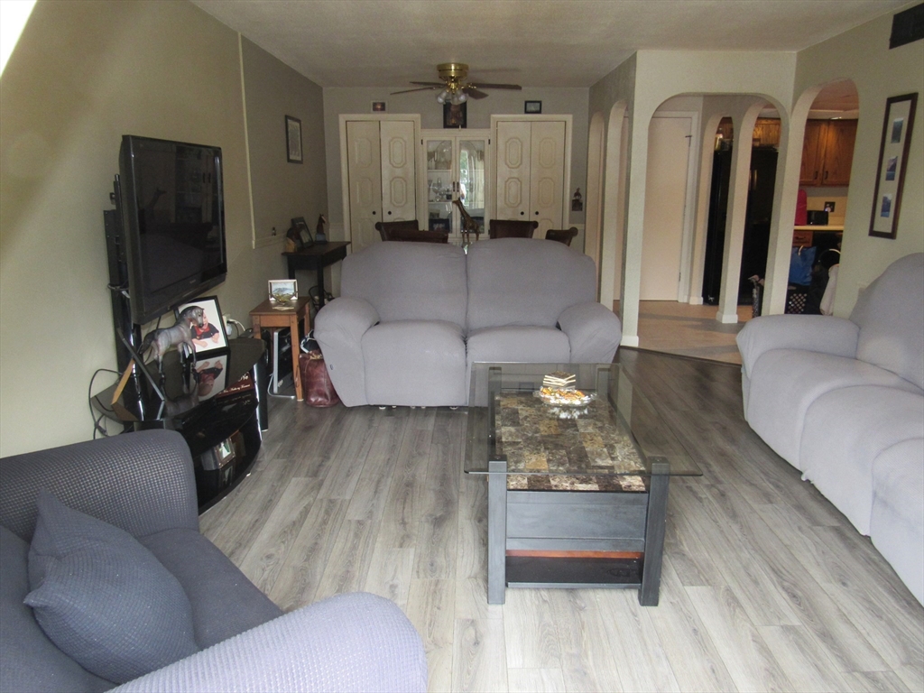 2 Shadowbrook Lane, Unit 50 Milford, MA 01757 - Photo 10 of 26 a living room with furniture and a flat screen tv