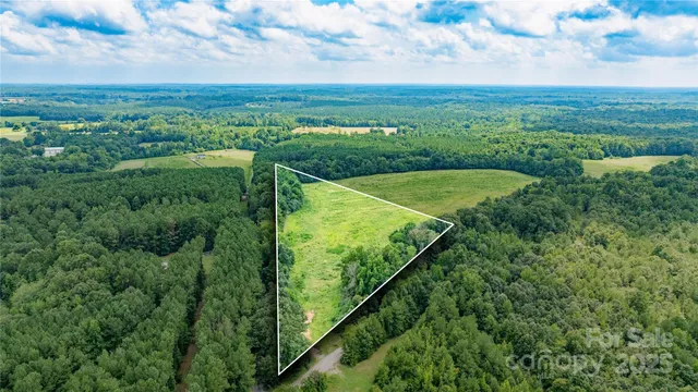 a view of a green field with an ocean