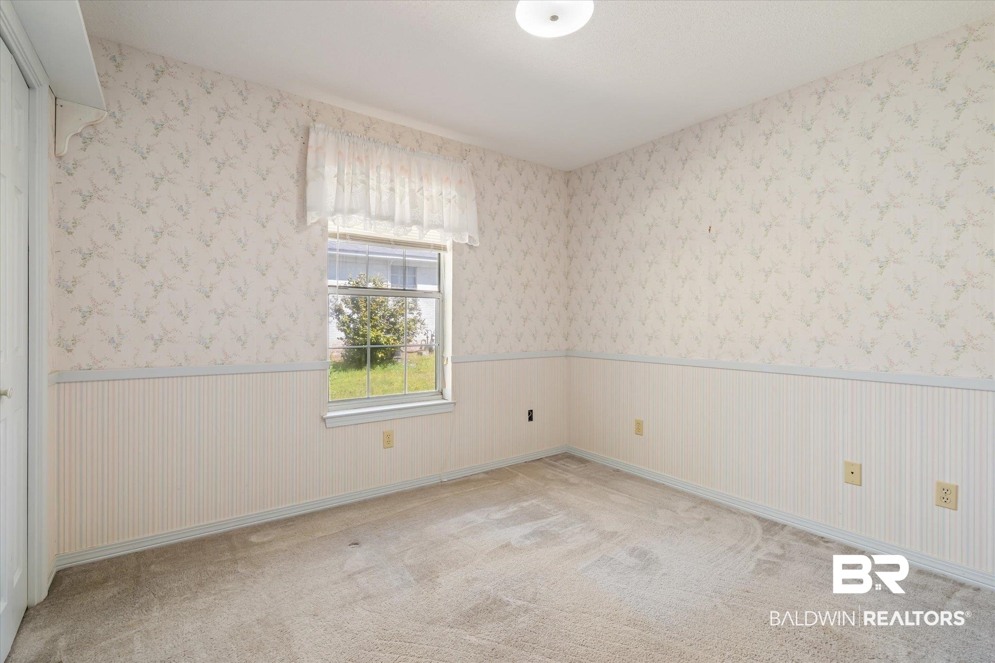 6030 Lott Road Eight Mile, AL 36613 - Photo 13 of 21 Carpeted empty room with wallpapered walls and wainscoting