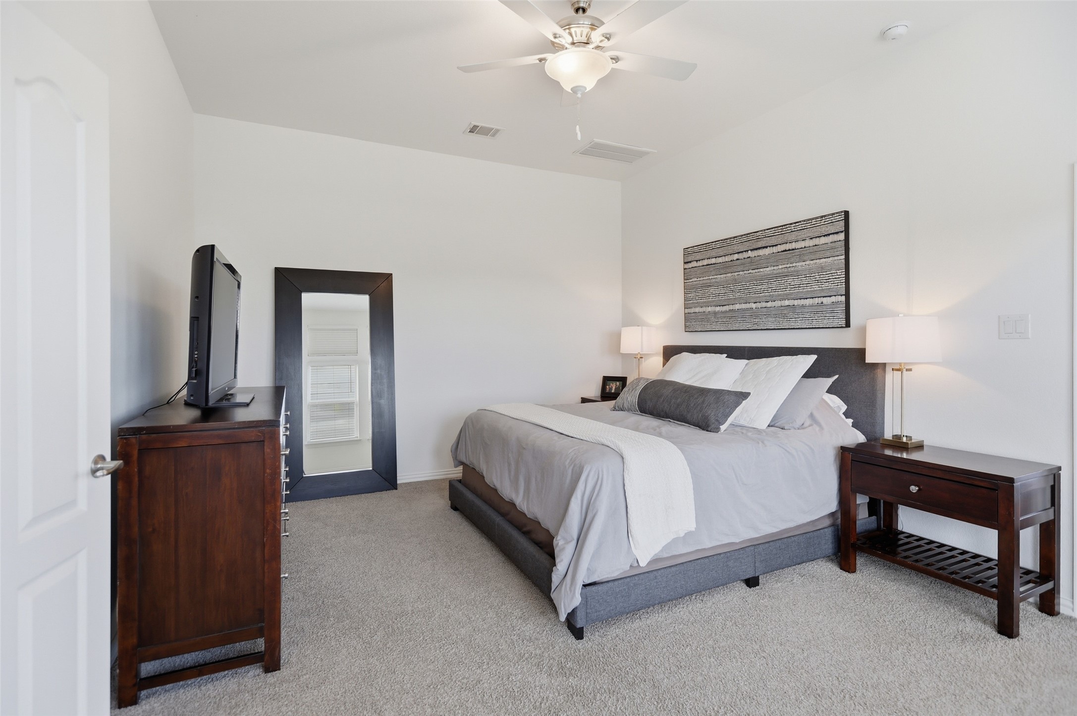 544 Cherrystone Loop Buda, TX 78610 - Photo 14 of 40 a bedroom with a bed and a chandelier