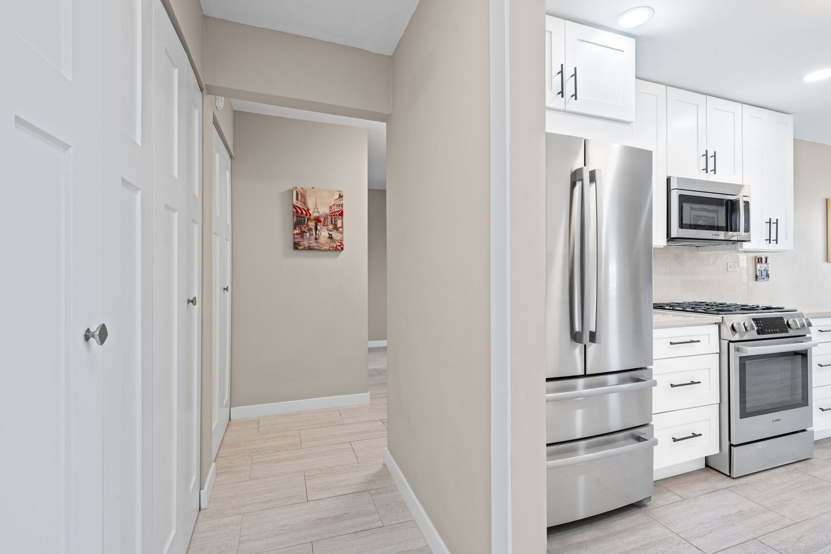 1205 East Hintz Road, Unit 209 Arlington Heights, IL 60004 - Photo 11 of 27 a kitchen with white cabinets and stainless steel appliances