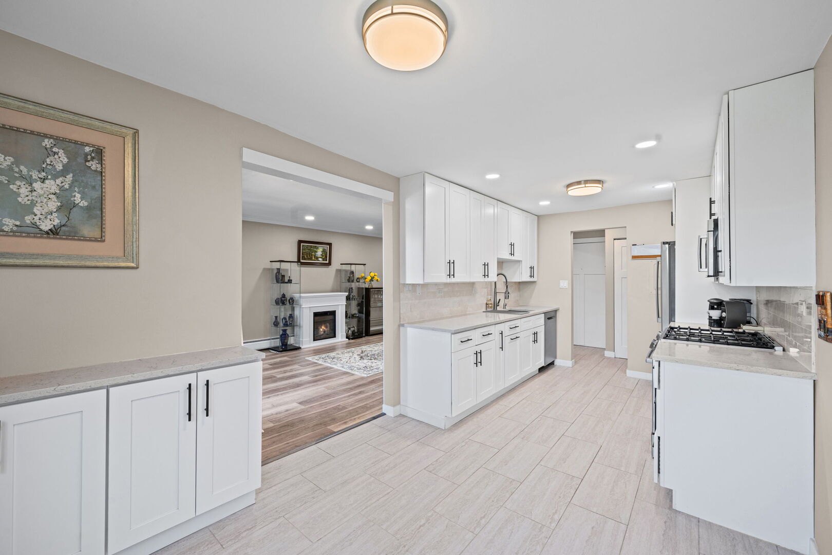 1205 East Hintz Road, Unit 209 Arlington Heights, IL 60004 - Photo 12 of 27 a large white kitchen with cabinets