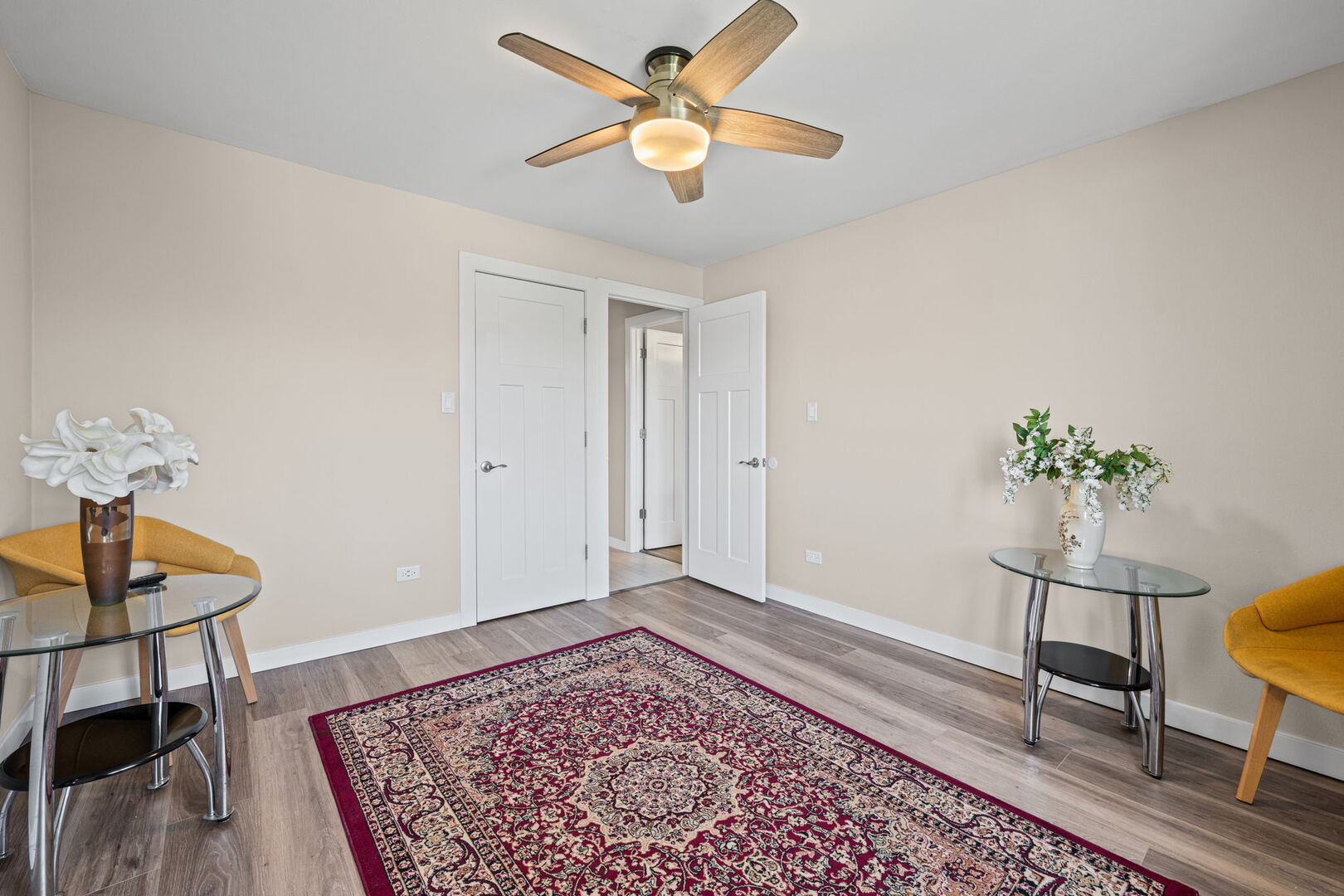 1205 East Hintz Road, Unit 209 Arlington Heights, IL 60004 - Photo 17 of 27 a living room with a dining table and a rug
