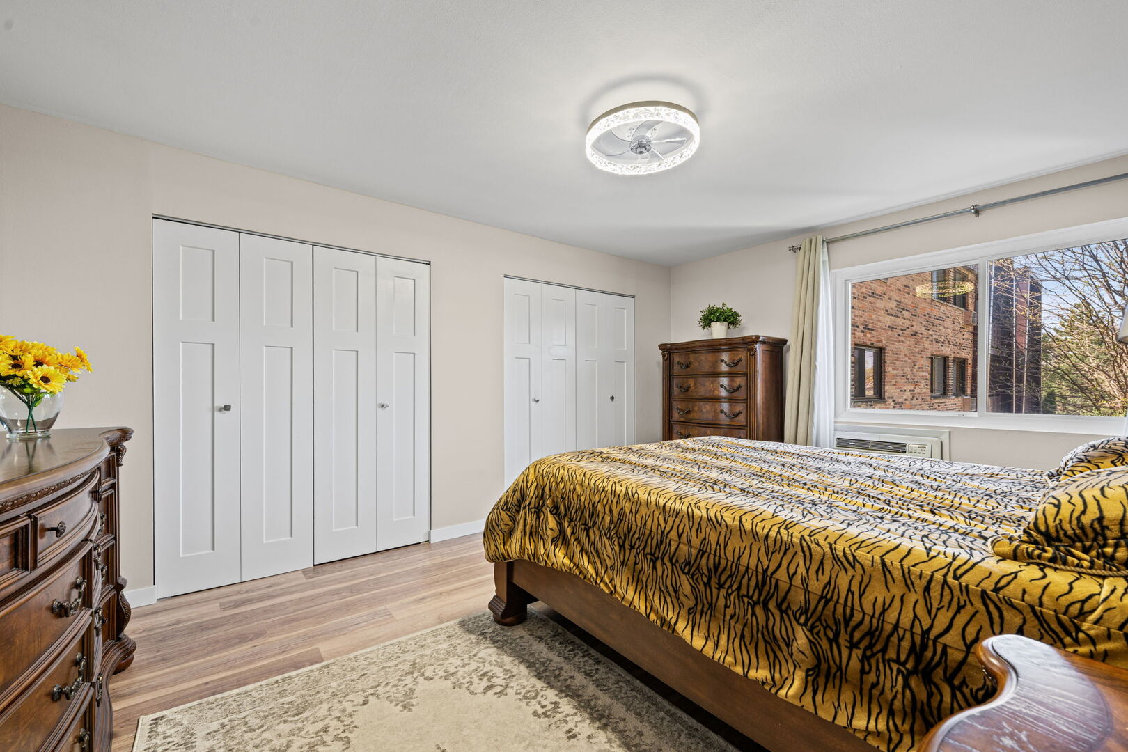 1205 East Hintz Road, Unit 209 Arlington Heights, IL 60004 - Photo 19 of 27 a bedroom with a bed and a dresser