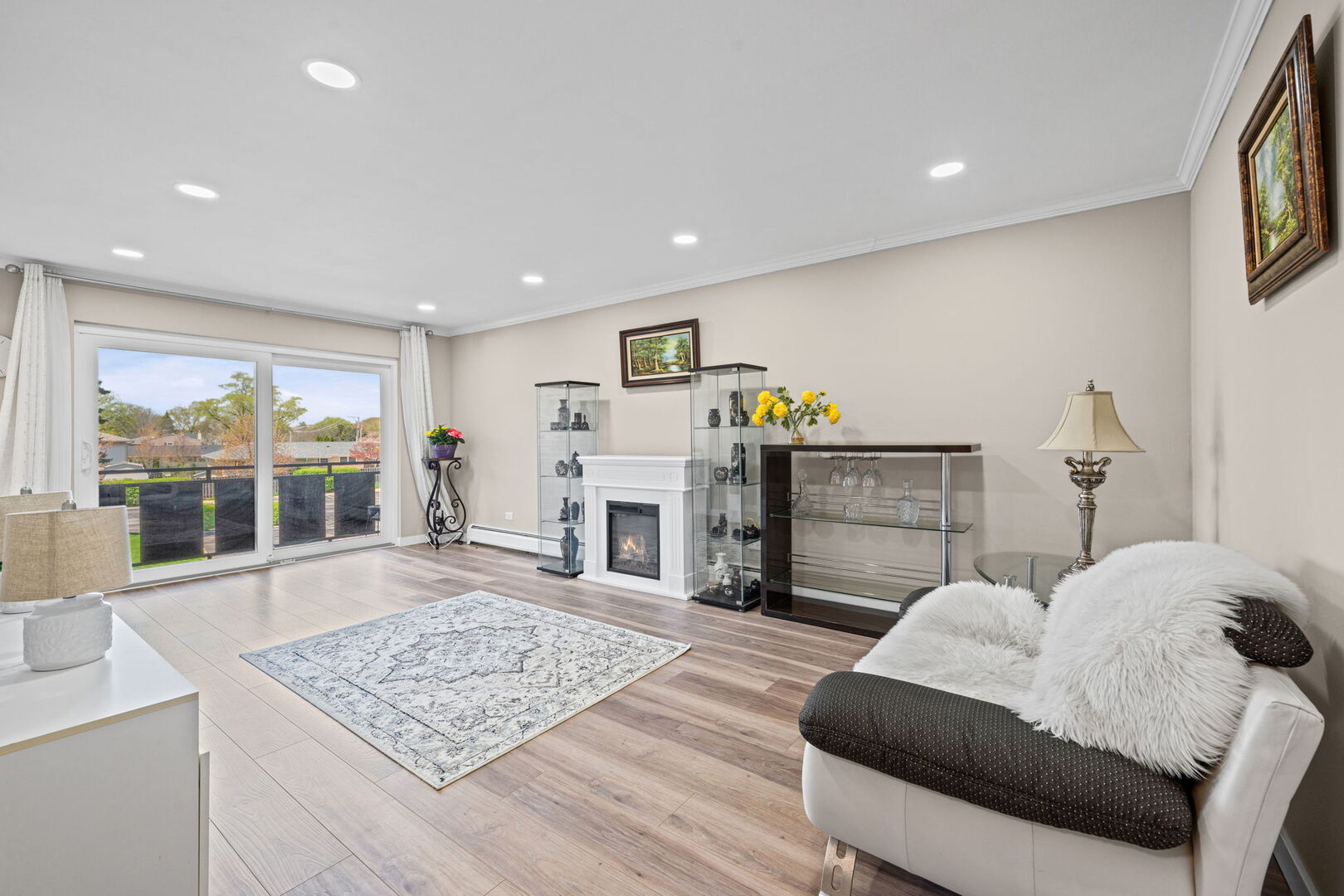 1205 East Hintz Road, Unit 209 Arlington Heights, IL 60004 - Photo 2 of 27 a living room with furniture and a fireplace