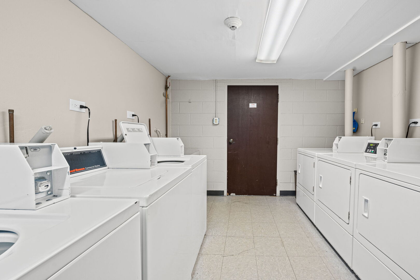 1205 East Hintz Road, Unit 209 Arlington Heights, IL 60004 - Photo 22 of 27 a large white room with a mirror and a sink