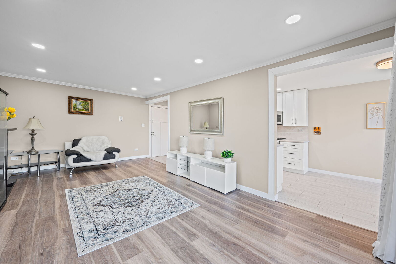 1205 East Hintz Road, Unit 209 Arlington Heights, IL 60004 - Photo 5 of 27 a living room with furniture and a wooden floor