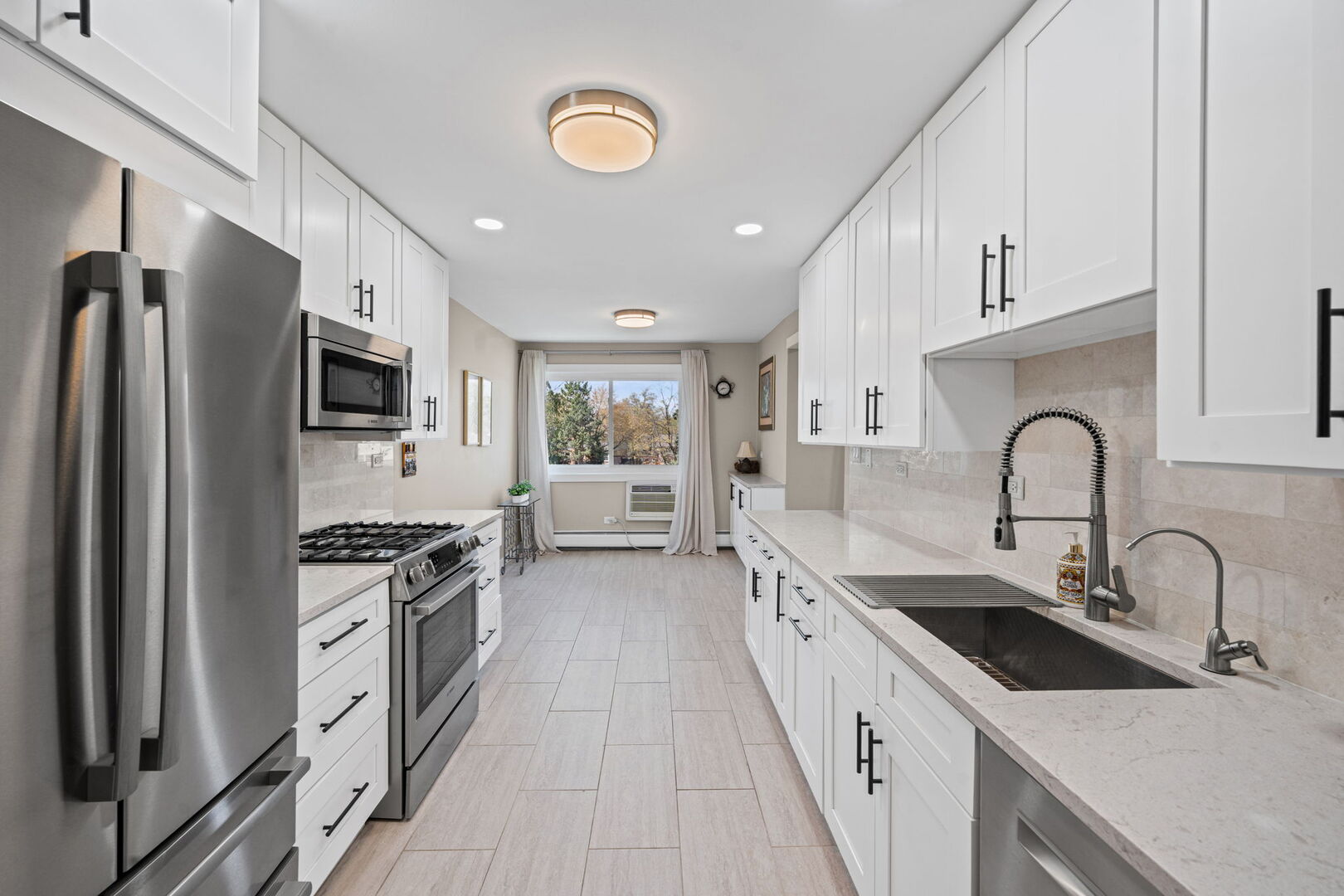 1205 East Hintz Road, Unit 209 Arlington Heights, IL 60004 - Photo 8 of 27 a kitchen with stainless steel appliances granite countertop a sink stove oven a refrigerator with white cabinets and stainless steel appliances