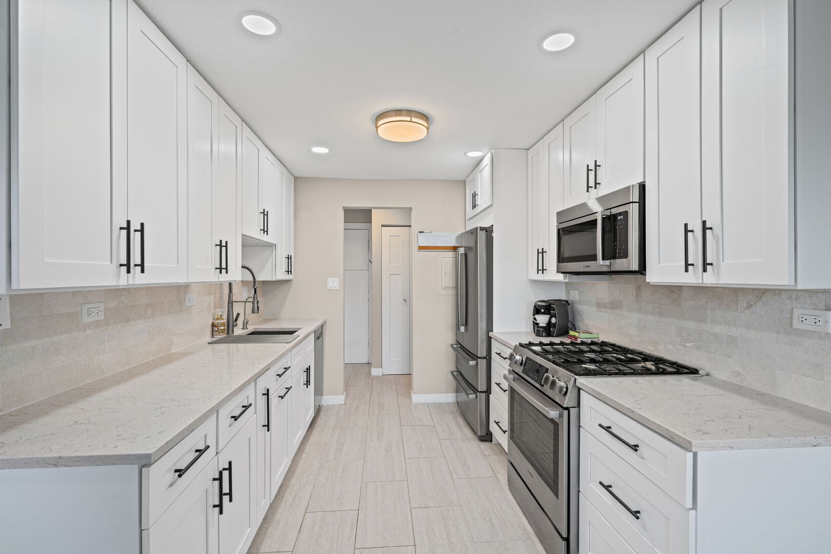 1205 East Hintz Road, Unit 209 Arlington Heights, IL 60004 - Photo 9 of 27 a kitchen with stainless steel appliances a sink stove and cabinets