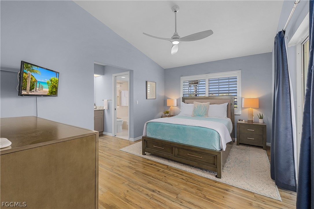 14983 Rivers Edge Court, Unit 232 Fort Myers, FL 33908 - Photo 11 of 27 a bedroom with a bed and a chandelier