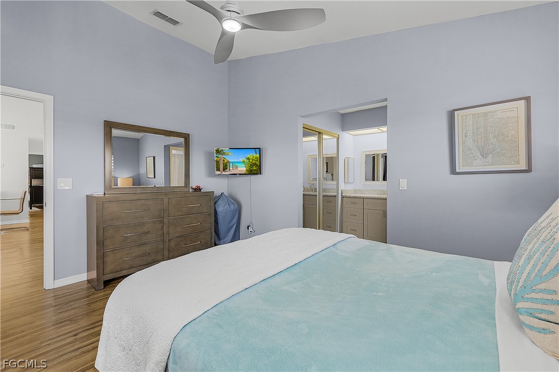 14983 Rivers Edge Court, Unit 232 Fort Myers, FL 33908 - Photo 12 of 27 a bedroom with a bed and a dresser