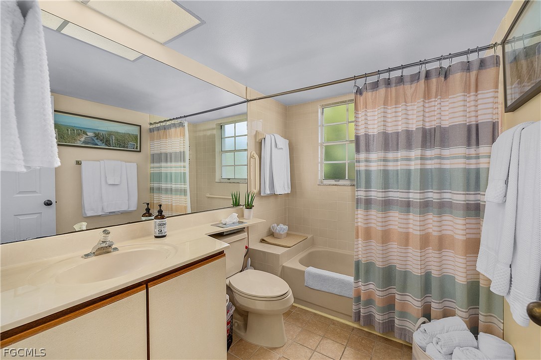 14983 Rivers Edge Court, Unit 232 Fort Myers, FL 33908 - Photo 19 of 27 a bathroom with a double vanity sink toilet and shower