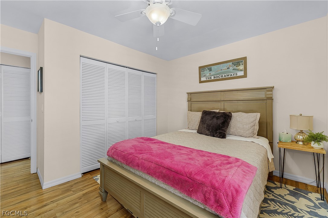 14983 Rivers Edge Court, Unit 232 Fort Myers, FL 33908 - Photo 21 of 27 a bedroom with a bed and a chandelier