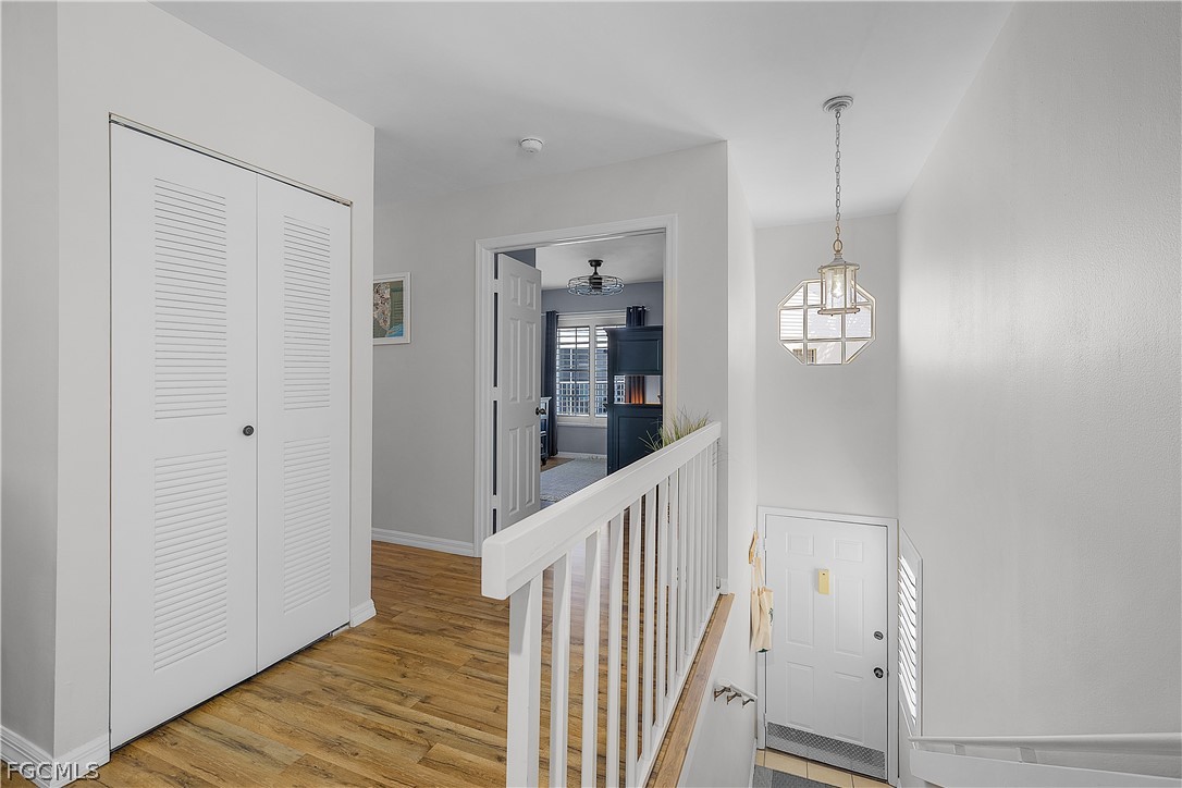14983 Rivers Edge Court, Unit 232 Fort Myers, FL 33908 - Photo 23 of 27 a view of a hallway with wooden floor and staircase