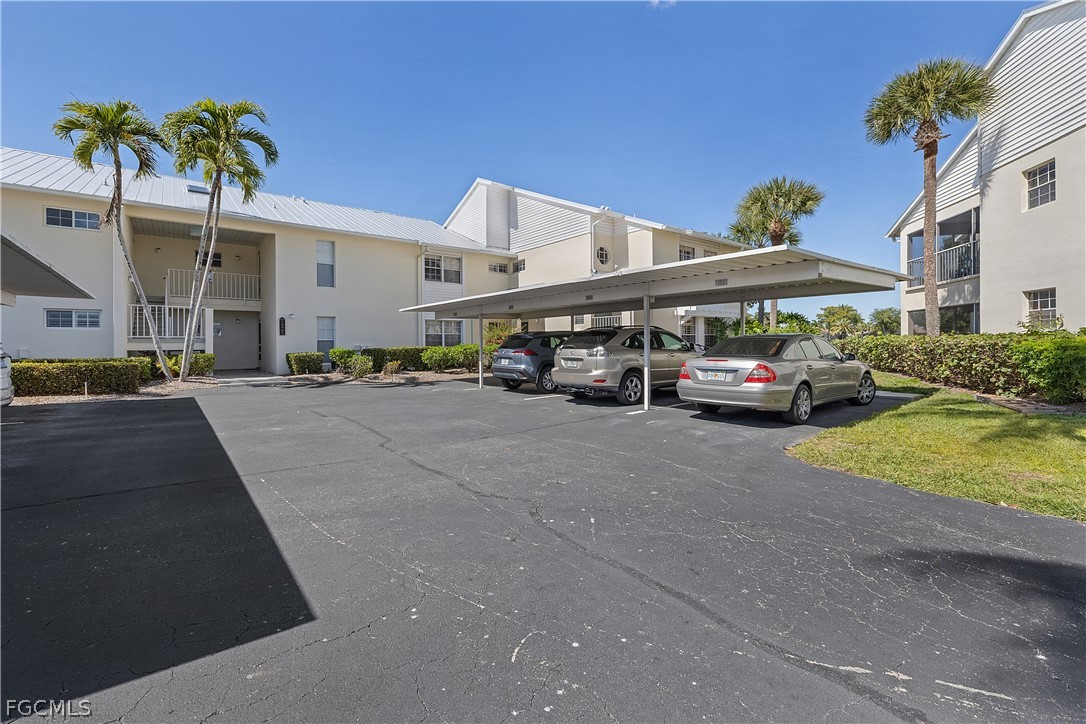 14983 Rivers Edge Court, Unit 232 Fort Myers, FL 33908 - Photo 25 of 27 a car parked in front of a building