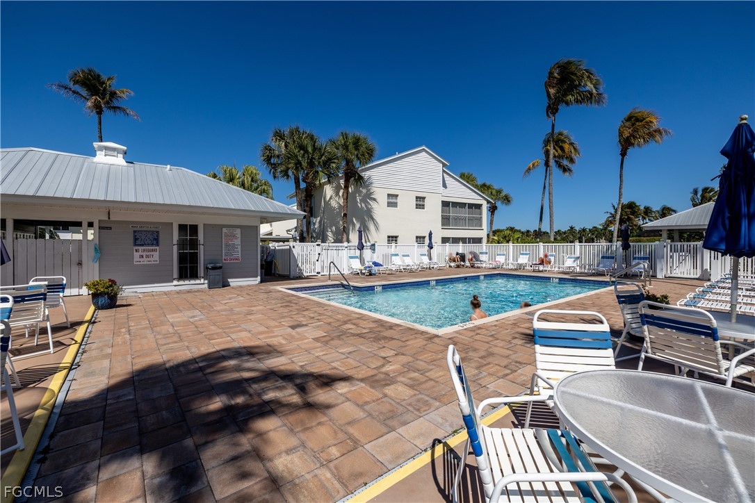 14983 Rivers Edge Court, Unit 232 Fort Myers, FL 33908 - Photo 26 of 27 a view of a house with pool and chairs