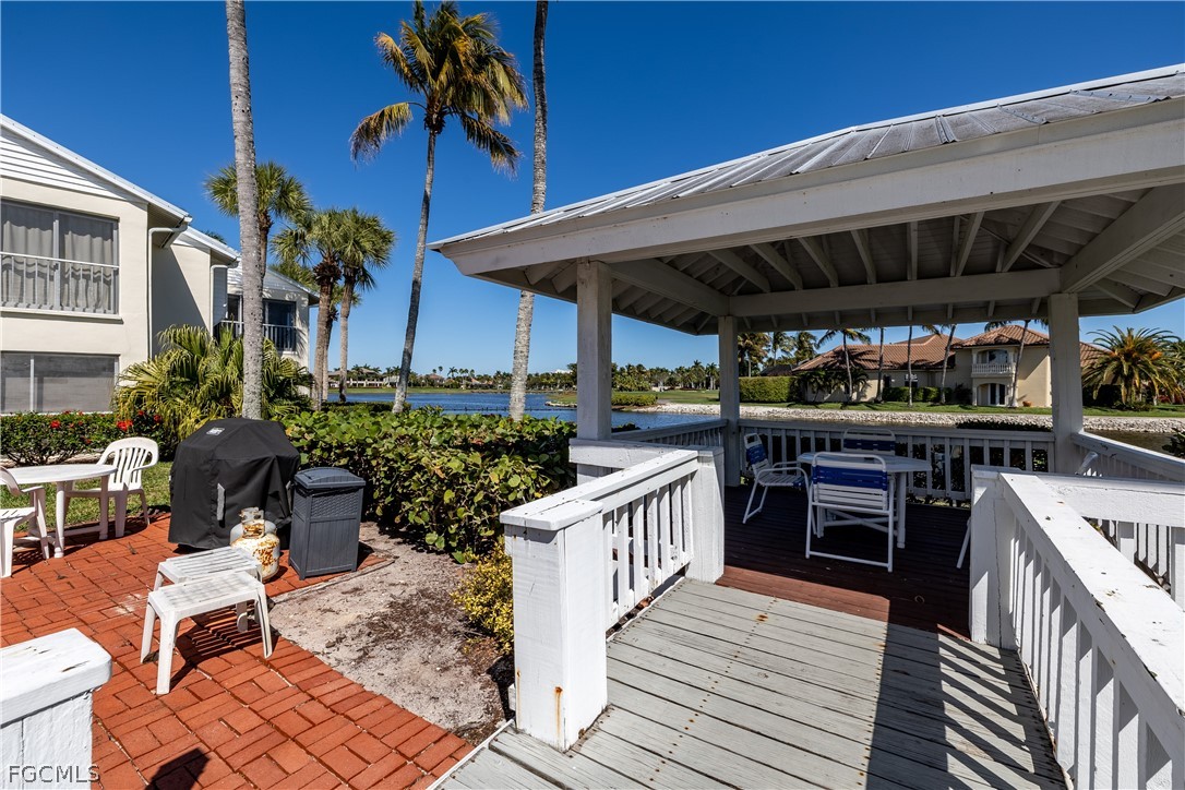 14983 Rivers Edge Court, Unit 232 Fort Myers, FL 33908 - Photo 27 of 27 a view of a deck with wooden floor a yard table and chairs