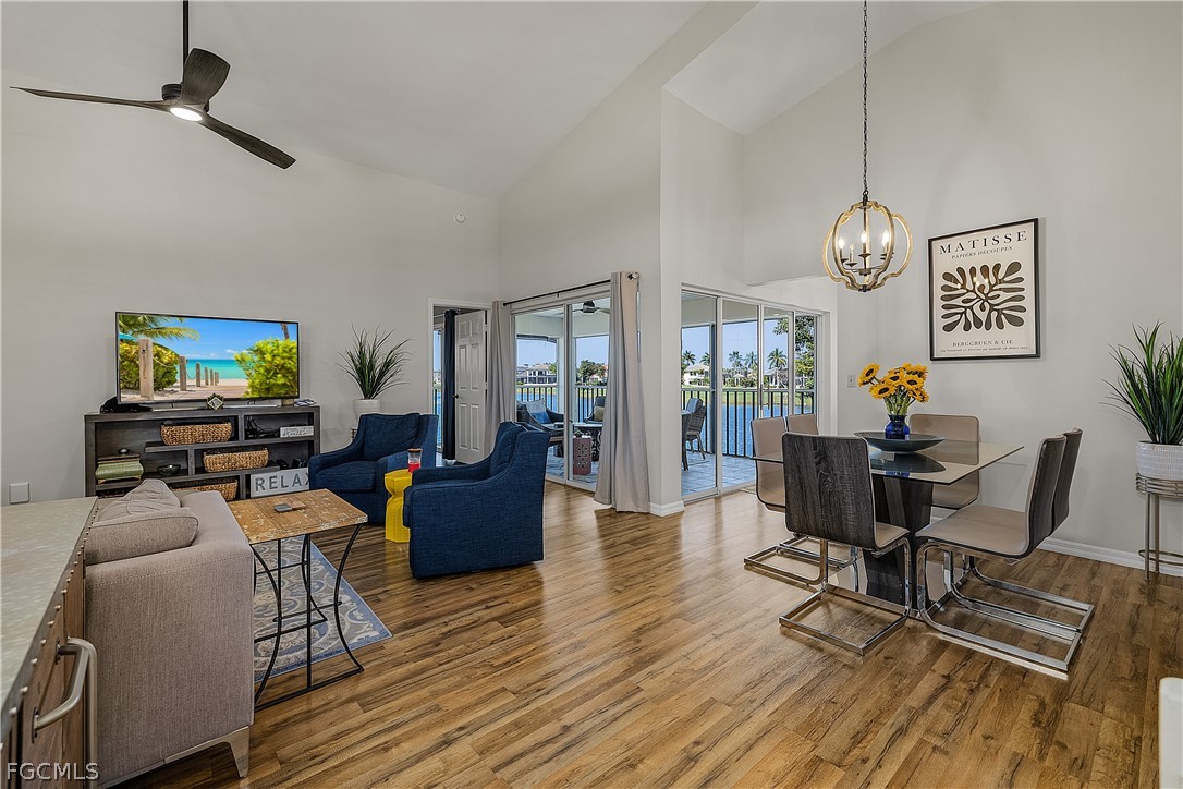 14983 Rivers Edge Court, Unit 232 Fort Myers, FL 33908 - Photo 3 of 27 a living room with furniture a flat screen tv and wooden floor