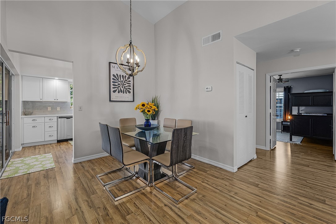 14983 Rivers Edge Court, Unit 232 Fort Myers, FL 33908 - Photo 8 of 27 a view of a dining room with furniture and wooden floor