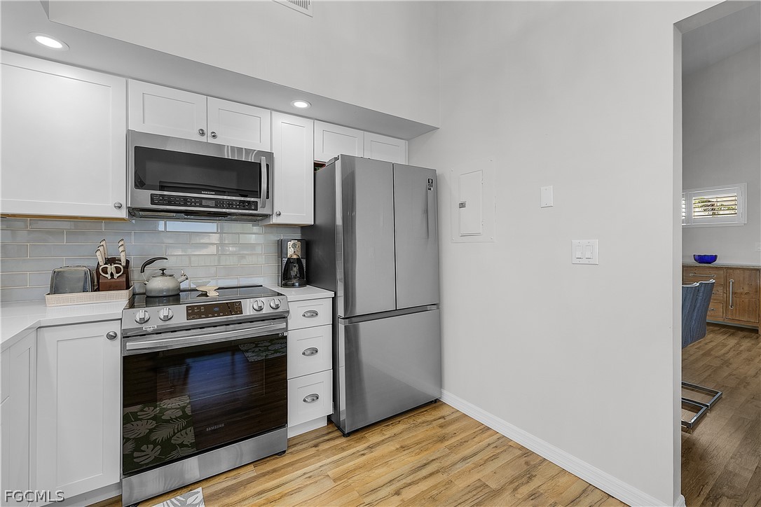 14983 Rivers Edge Court, Unit 232 Fort Myers, FL 33908 - Photo 10 of 27 a kitchen with a stove microwave and refrigerator
