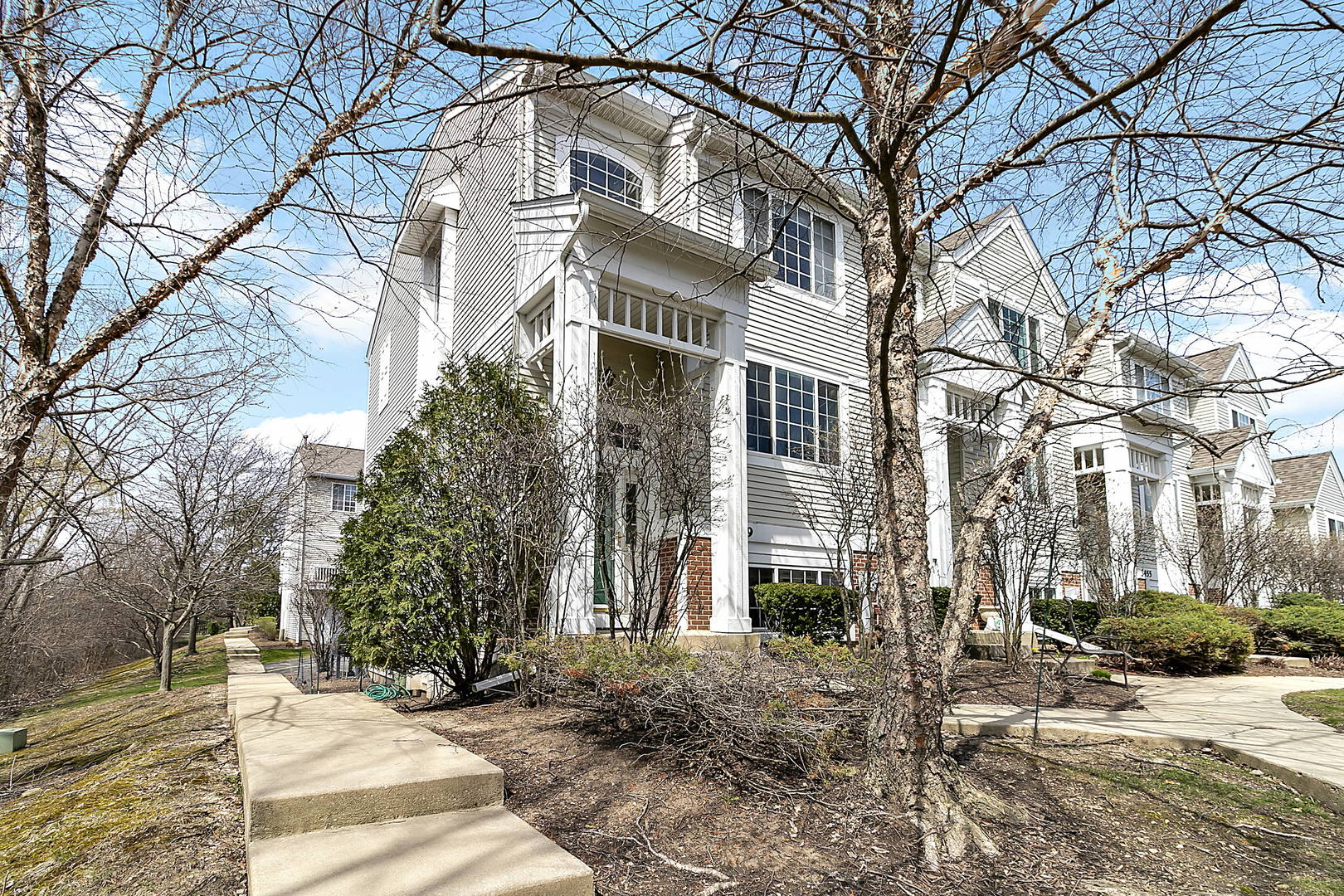 3459 Ravinia Circle, Unit 3459 Aurora, IL 60504 - Photo 1 of 18 a front view of a building with trees