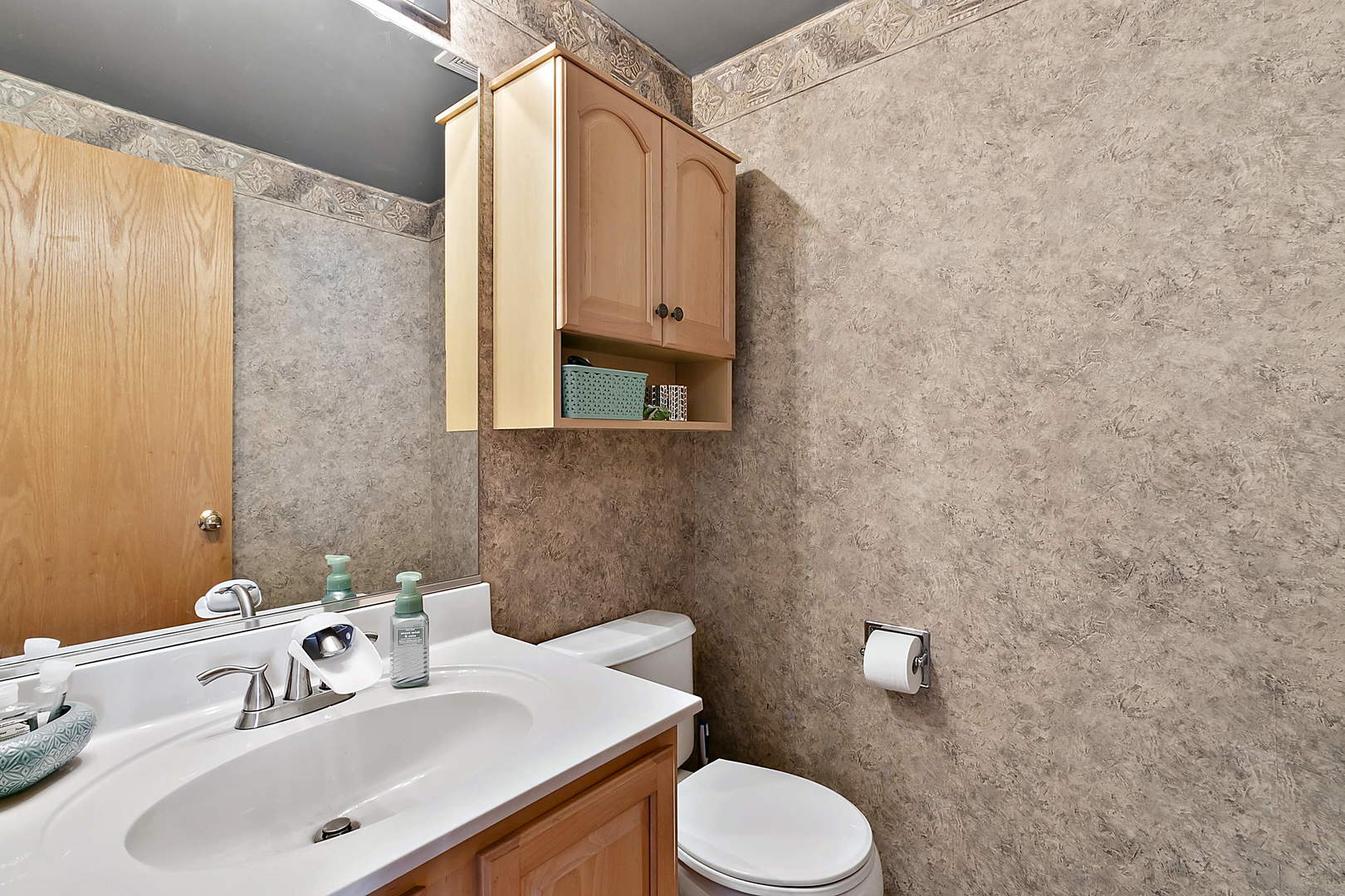 3459 Ravinia Circle, Unit 3459 Aurora, IL 60504 - Photo 11 of 18 a bathroom with a sink and a toilet