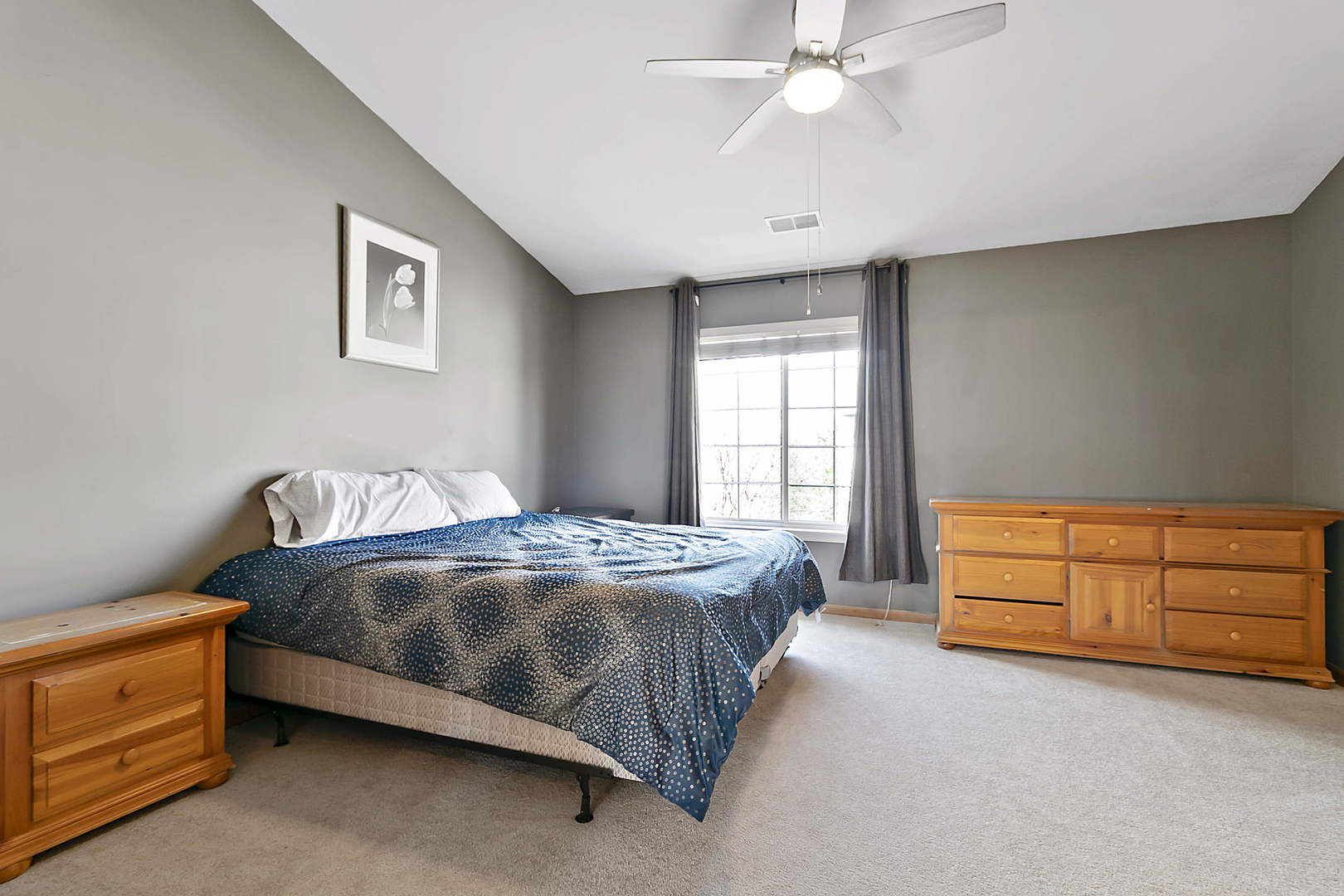 3459 Ravinia Circle, Unit 3459 Aurora, IL 60504 - Photo 13 of 18 a spacious bedroom with a bed and a dresser
