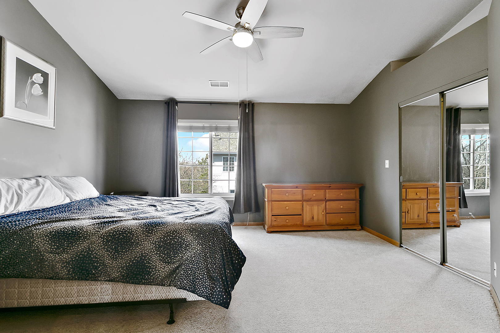 3459 Ravinia Circle, Unit 3459 Aurora, IL 60504 - Photo 14 of 18 a bedroom with a bed and a cabinets