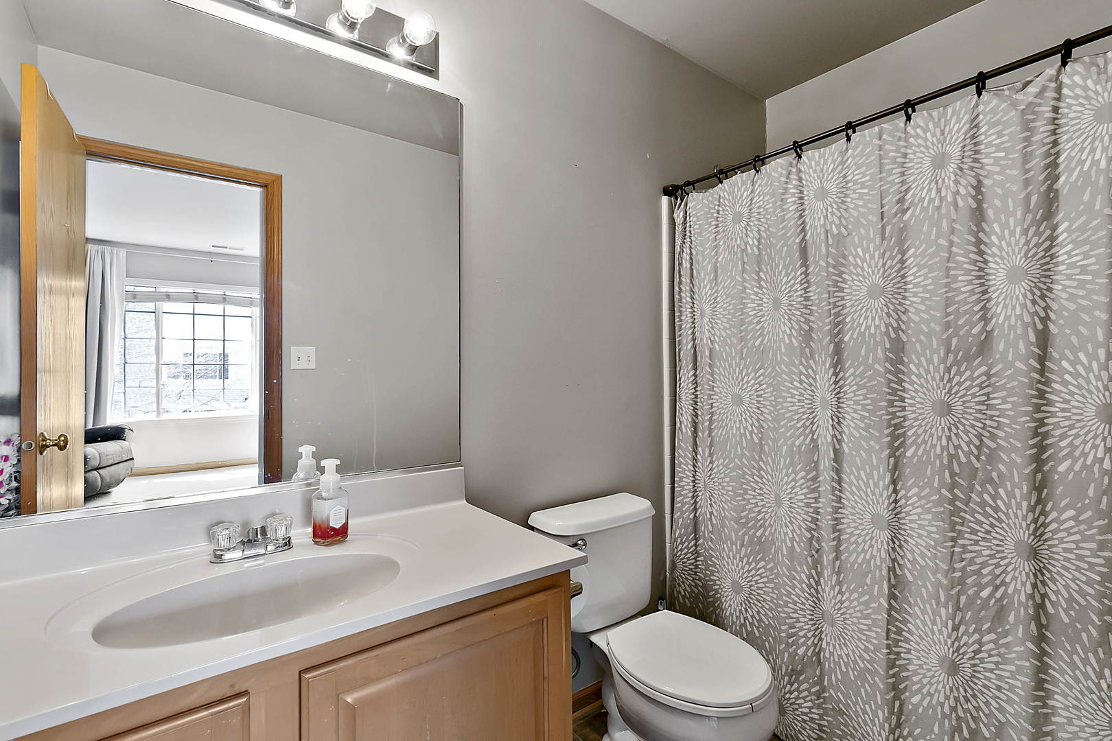 3459 Ravinia Circle, Unit 3459 Aurora, IL 60504 - Photo 17 of 18 a bathroom with a sink a toilet and shower